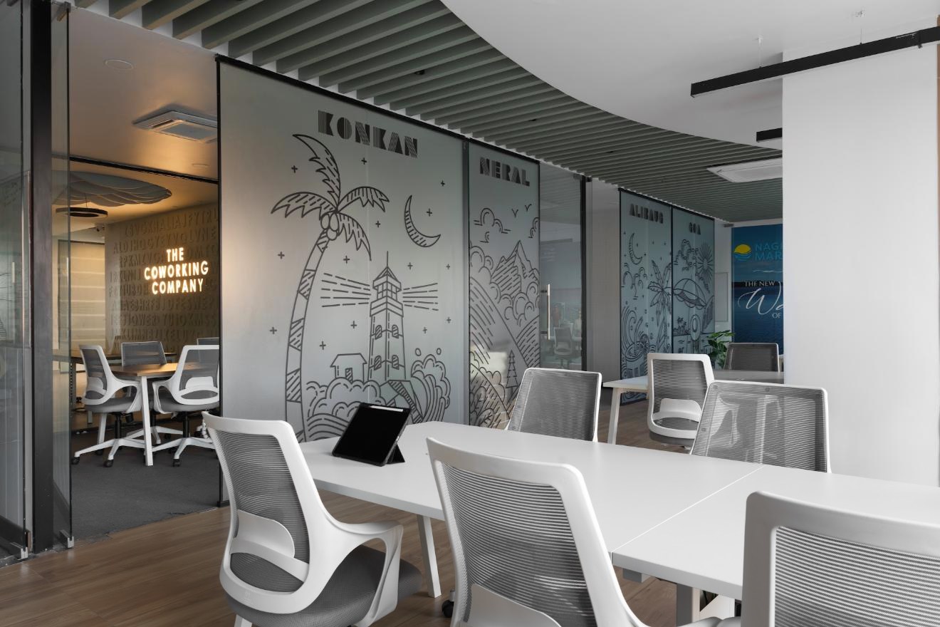 Dedicated workstations beside illustrated glass partitions